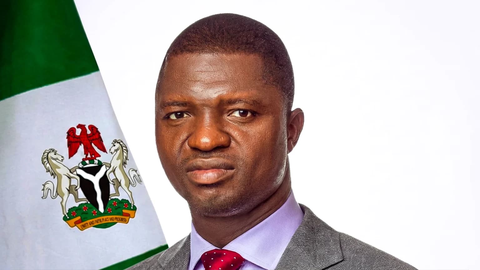 Ebonyi State Governor Francis Nwifuru in a formal portrait beside a Nigerian flag