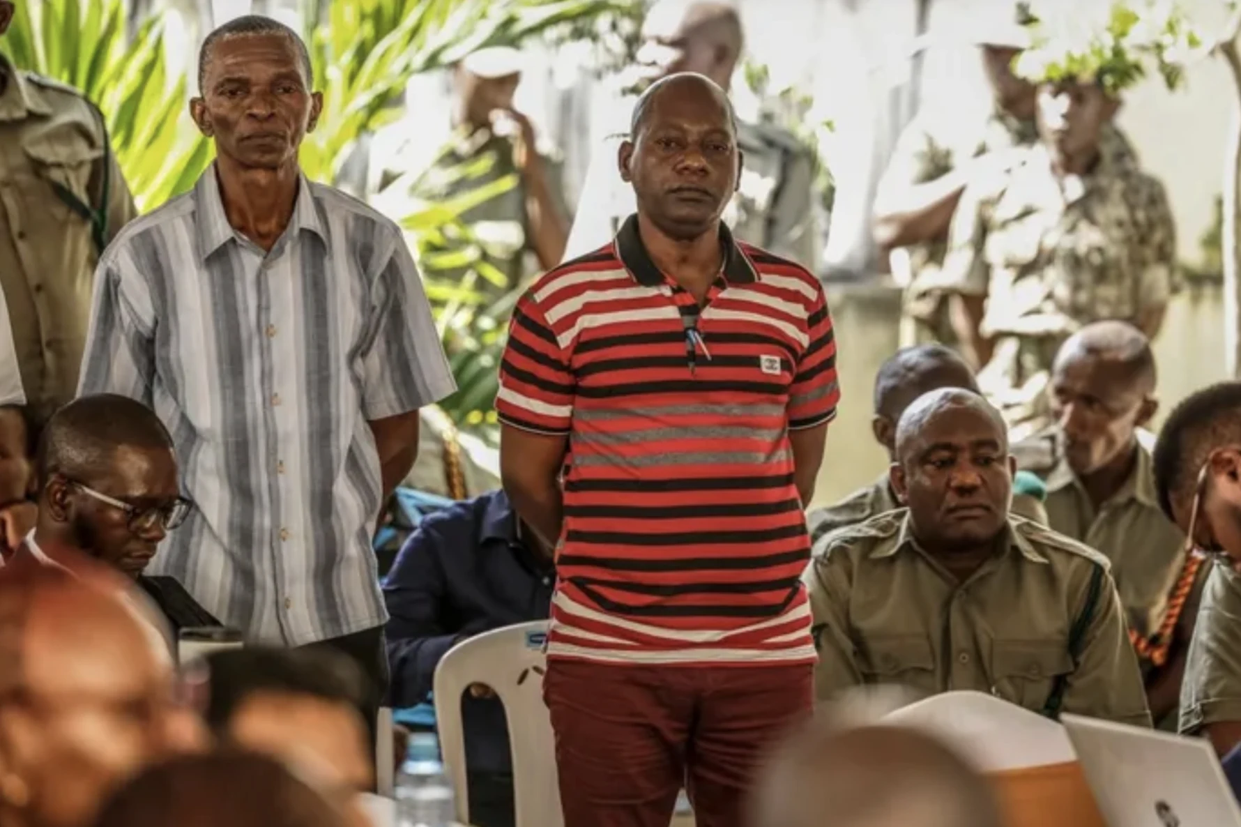 Defendants standing under guard during a court session in the Shakahola starvation cult case in Kenya